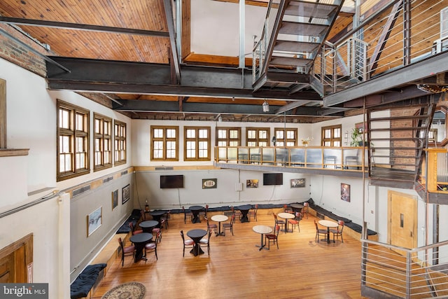 workout room with light hardwood / wood-style flooring and wooden ceiling