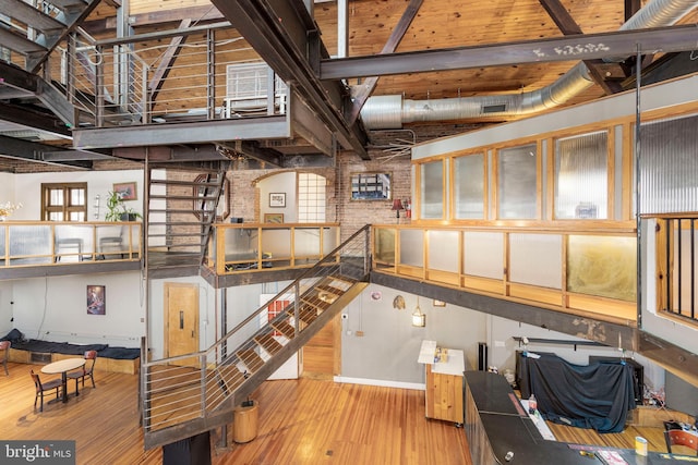 basement with brick wall and wood-type flooring