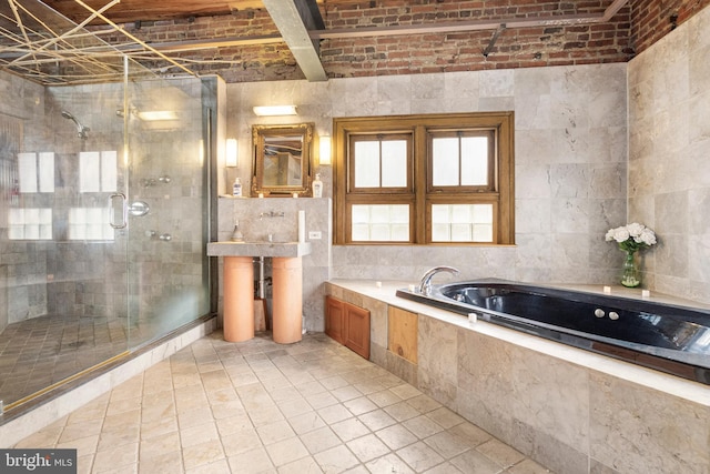 bathroom featuring tile walls, separate shower and tub, and vanity with extensive cabinet space