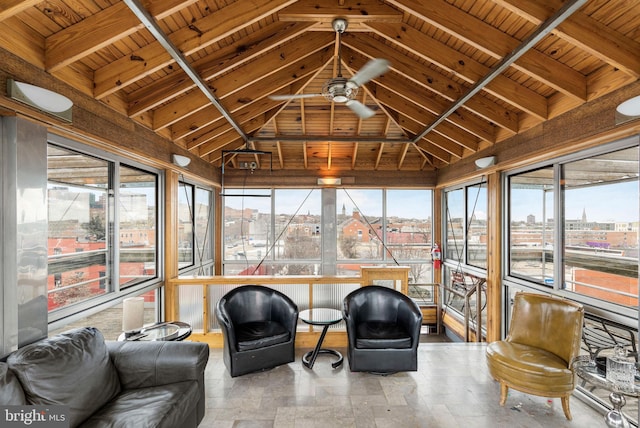 sunroom / solarium with a healthy amount of sunlight, ceiling fan, wood ceiling, and lofted ceiling with beams