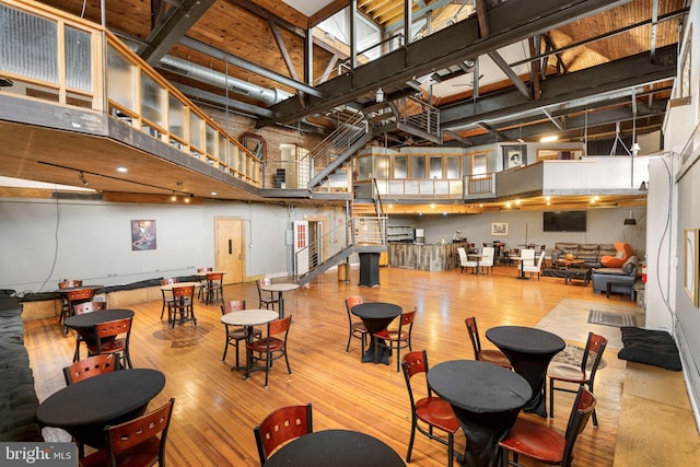 interior space featuring light hardwood / wood-style floors and a towering ceiling