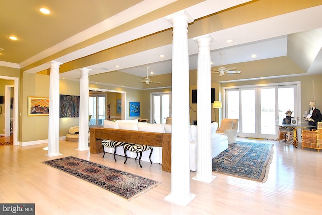 interior space with ceiling fan, light hardwood / wood-style flooring, and ornate columns