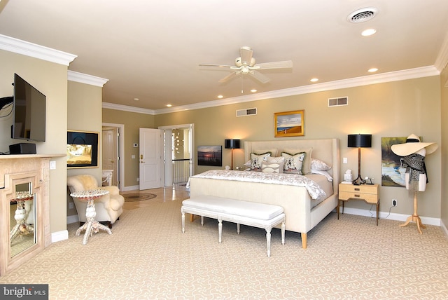 carpeted bedroom with ornamental molding and ceiling fan