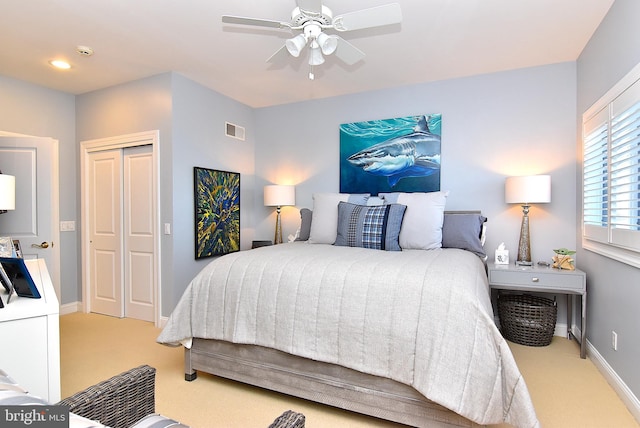 carpeted bedroom with a closet and ceiling fan