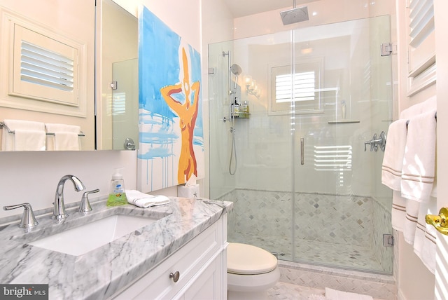 bathroom featuring tile floors, an enclosed shower, toilet, and vanity