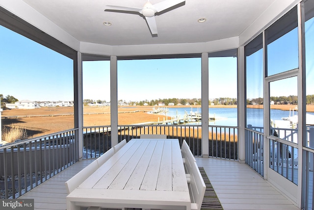 deck featuring a water view and ceiling fan