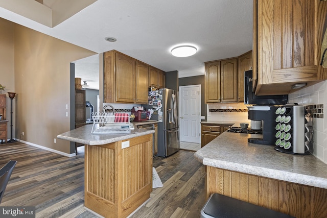 kitchen with backsplash, dark wood-type flooring, and sink