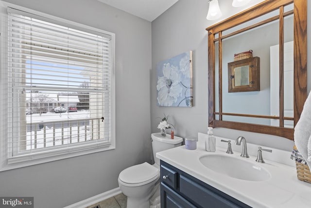 bathroom featuring tile floors, toilet, and vanity