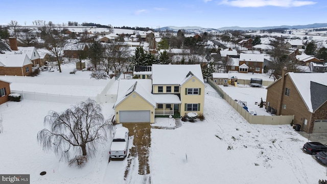 snowy aerial view with a mountain view