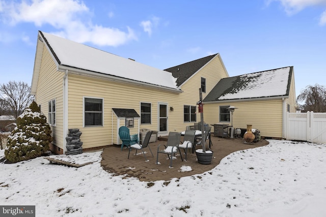 snow covered house with a patio