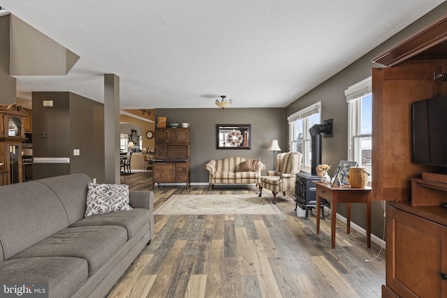 living room featuring dark wood-type flooring and a wood stove