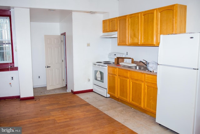 kitchen featuring light tile flooring, white appliances, and sink