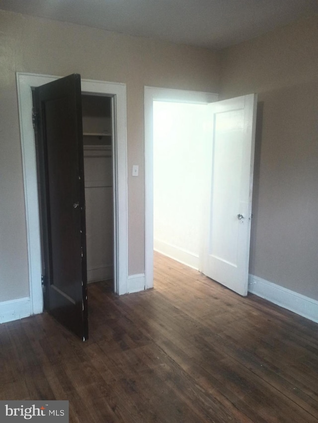 unfurnished bedroom featuring dark wood-type flooring