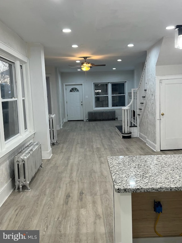 interior space featuring light wood-type flooring and radiator heating unit