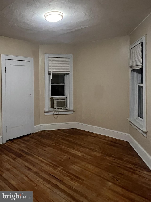 unfurnished room with dark hardwood / wood-style floors