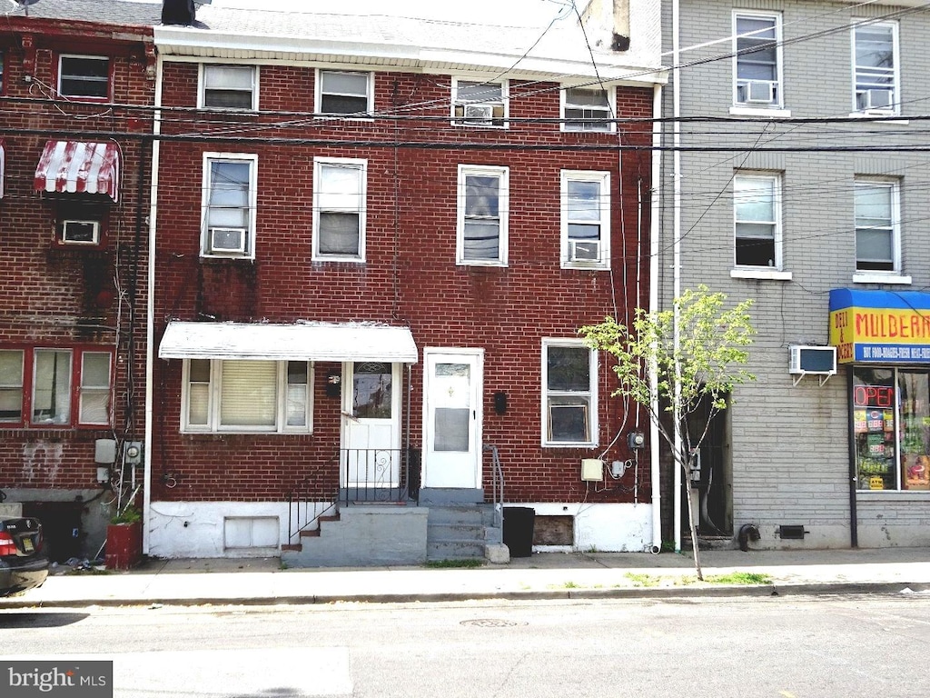 view of property with a wall unit AC