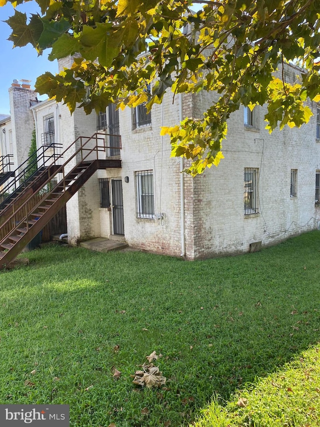 rear view of house with a yard