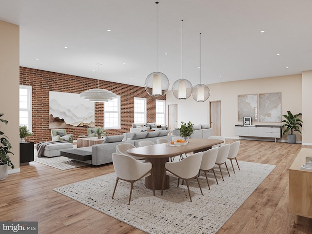 dining room featuring light hardwood / wood-style flooring and brick wall