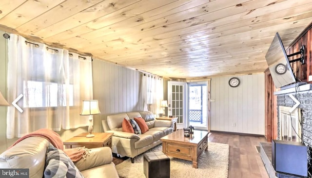 living room with wood ceiling, dark wood-type flooring, and a healthy amount of sunlight