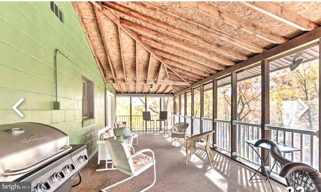 sunroom / solarium featuring vaulted ceiling