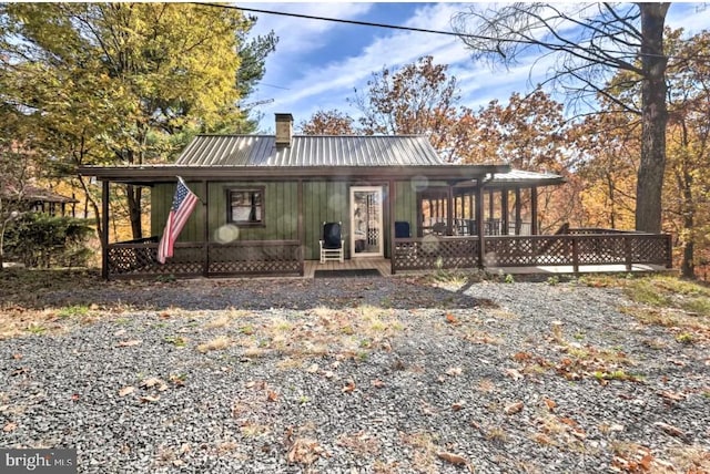 back of property with covered porch