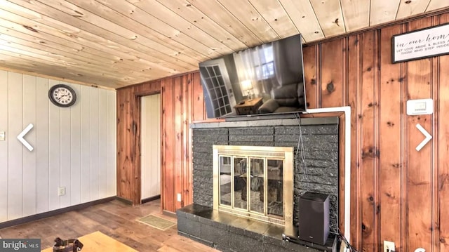 unfurnished living room with wood walls, dark wood-type flooring, and wood ceiling