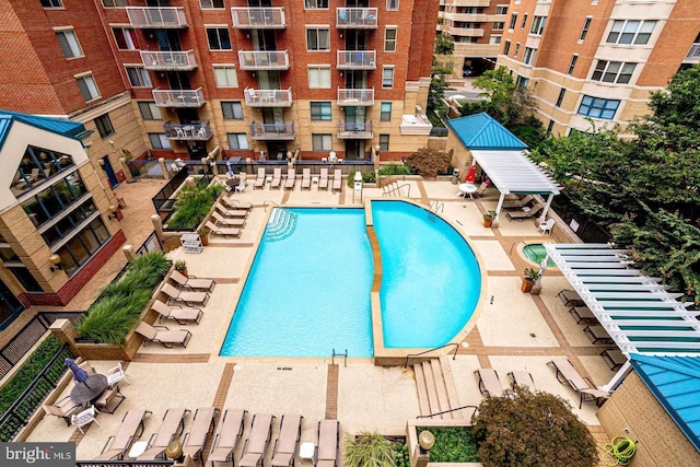 view of swimming pool featuring a patio area and central air condition unit