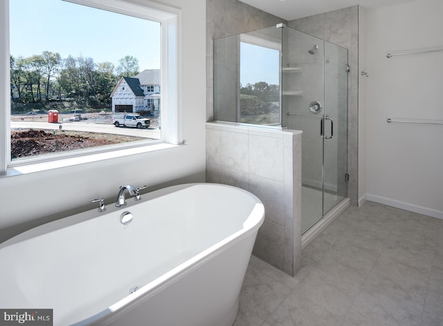 bathroom featuring plus walk in shower and a wealth of natural light