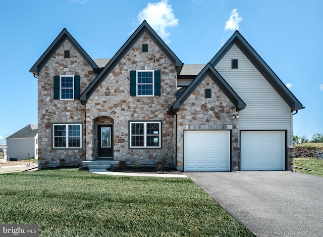 view of front of house featuring a front yard and a garage