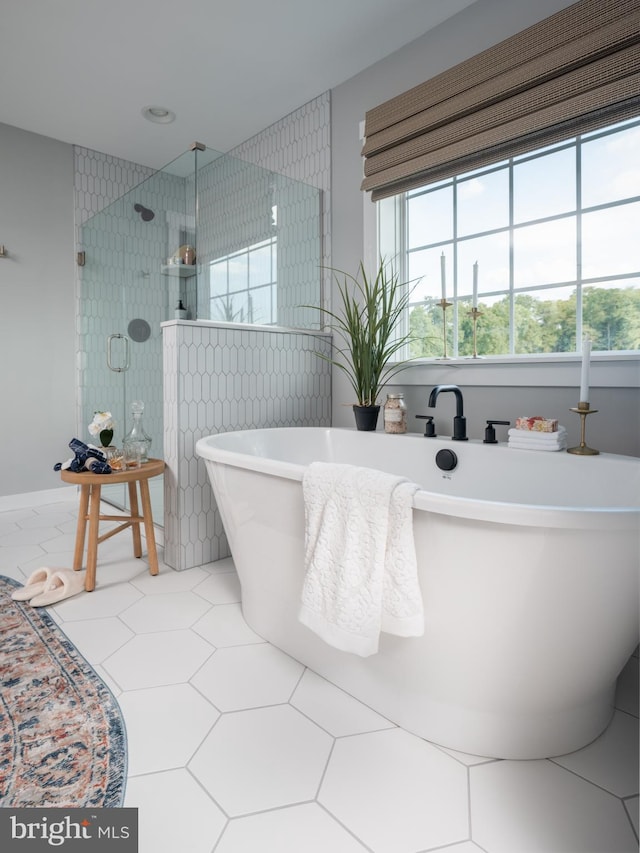 bathroom featuring independent shower and bath and tile patterned floors