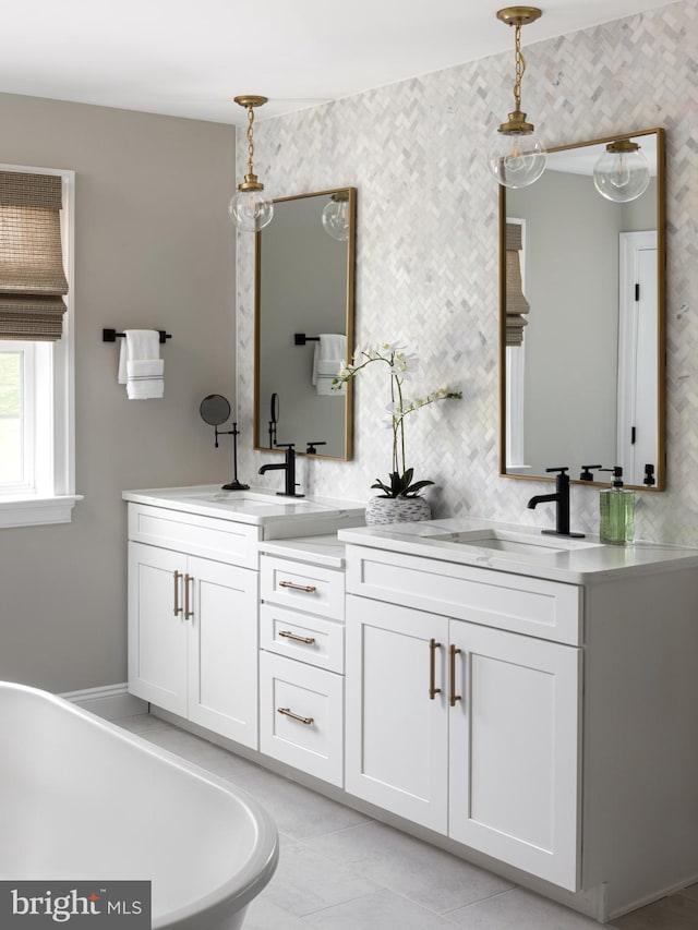 bathroom featuring vanity, a tub, and tile patterned flooring