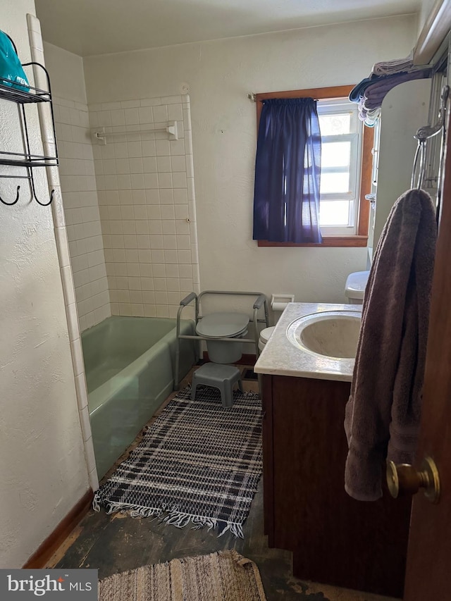 full bathroom featuring toilet, vanity, and tiled shower / bath