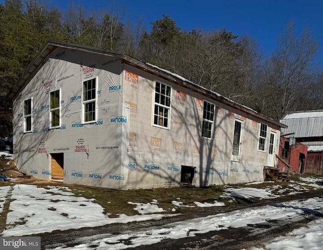 snow covered property with central AC unit