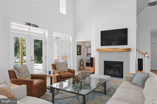 living room with a high ceiling, french doors, and dark wood-type flooring