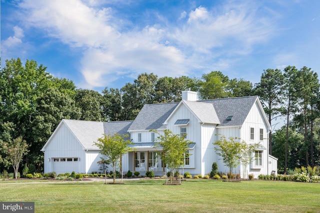 modern inspired farmhouse featuring a front yard and a garage