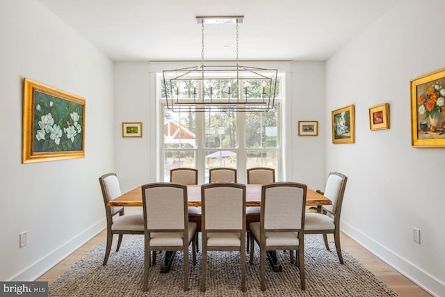 dining space with an inviting chandelier and wood-type flooring