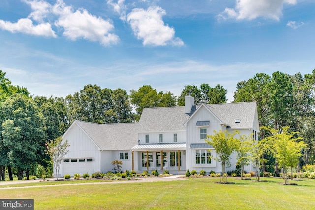 view of front of house with a front yard and a garage