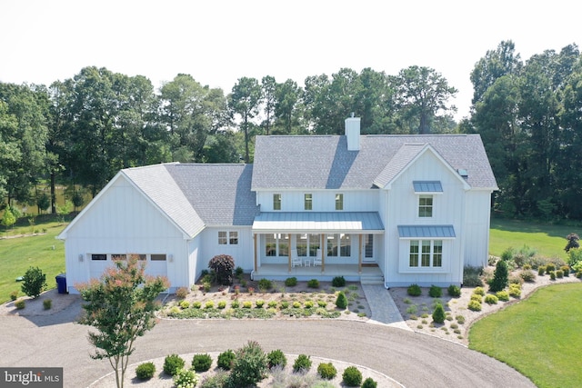 modern farmhouse style home featuring a front lawn and covered porch