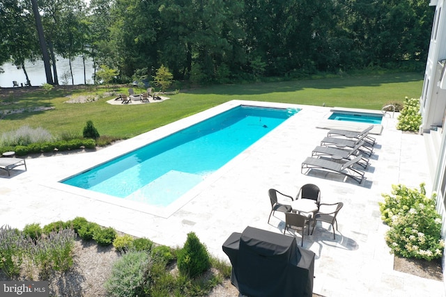 view of swimming pool featuring a patio and a lawn