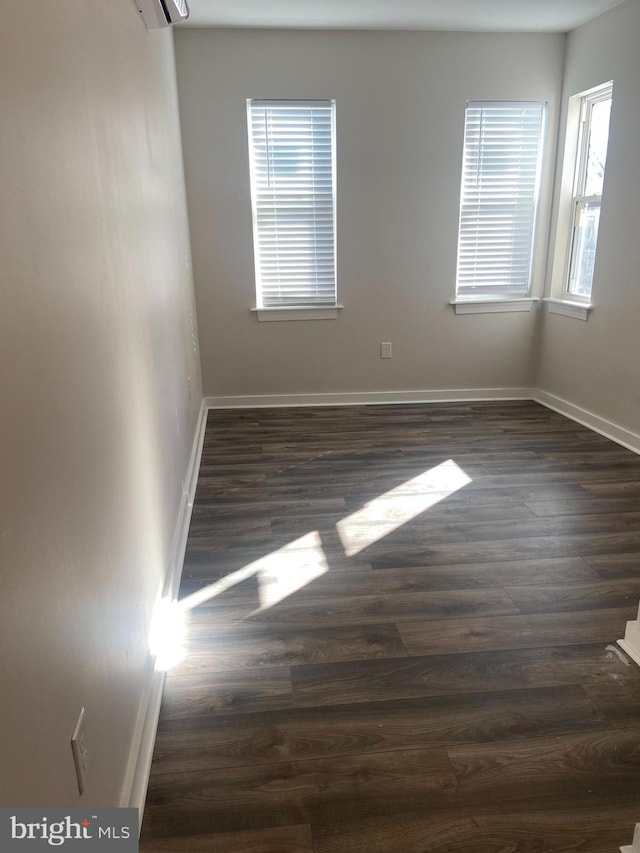 unfurnished room featuring dark hardwood / wood-style flooring