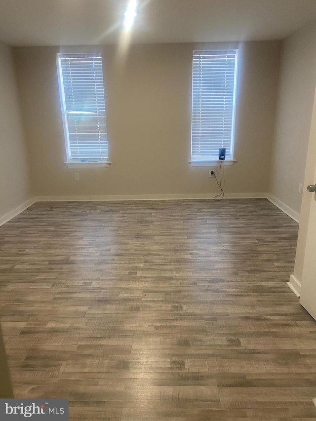 empty room with dark wood-type flooring