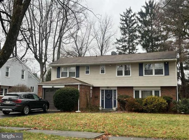 view of front of house with a front yard and a garage