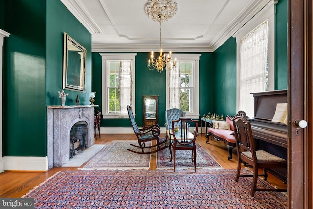 dining room with an inviting chandelier, ornamental molding, and light wood-type flooring