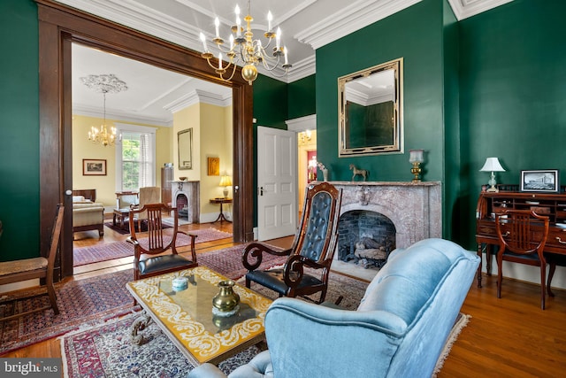 living room featuring a chandelier, dark hardwood / wood-style floors, and ornamental molding