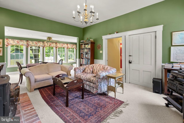 living room with carpet flooring and ceiling fan with notable chandelier