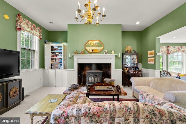 carpeted living room featuring a chandelier