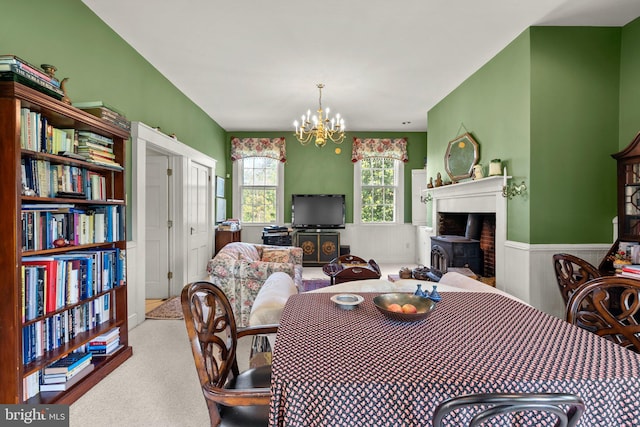 dining space with light colored carpet and a notable chandelier