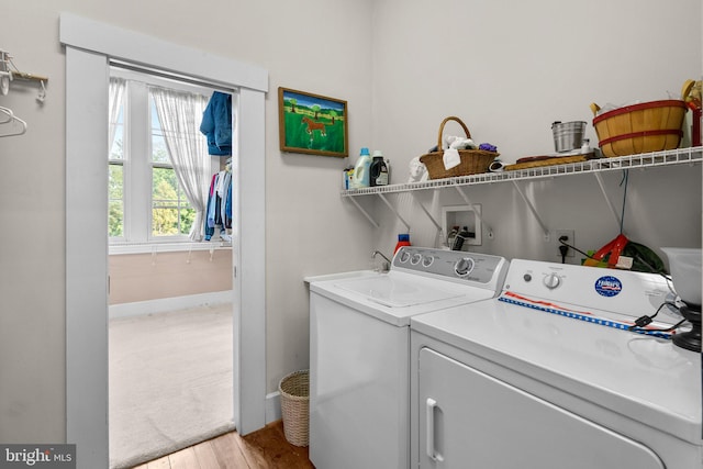 clothes washing area featuring light carpet, hookup for a washing machine, and independent washer and dryer