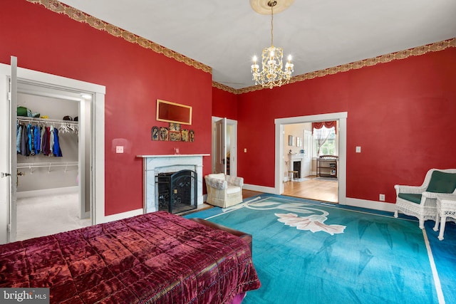 carpeted bedroom with a closet and a notable chandelier