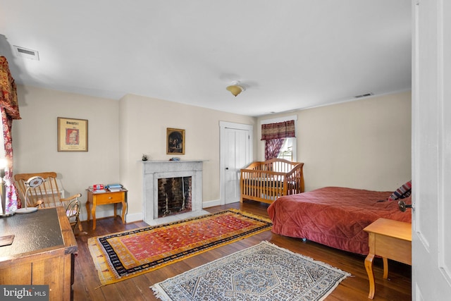 bedroom with a closet and dark hardwood / wood-style floors